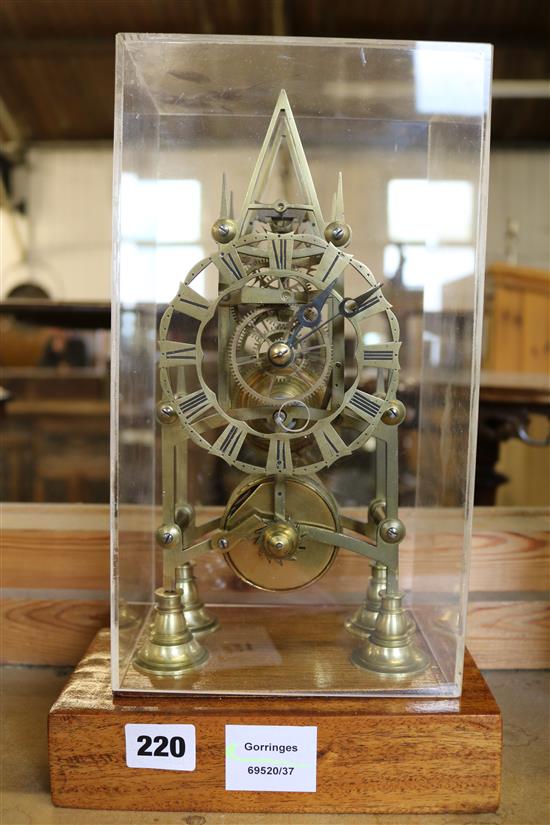 A Victorian brass eight day skeleton timepiece